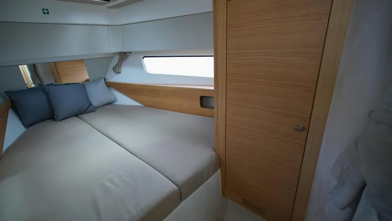Slide: The Image of Cozy cabin interior of 2025 Nimbus Weekender 11, featuring a comfortable bed and wooden accents. - 30
