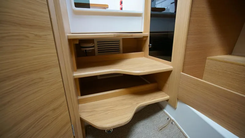 Slide: The Image of Interior of 2025 Nimbus Weekender 11 #49, featuring wooden steps and storage compartments. - 34