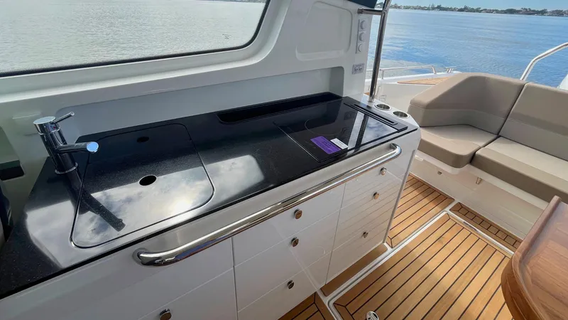 Slide: The Image of Modern kitchenette on 2025 Nimbus Weekender 11 yacht with sleek design and waterfront view. - 4