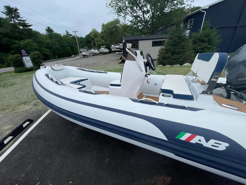 Slide: The Image of 2025 AB Inflatables Alumina 13 ALX with Yamaha outboard motor, parked on asphalt. - 1