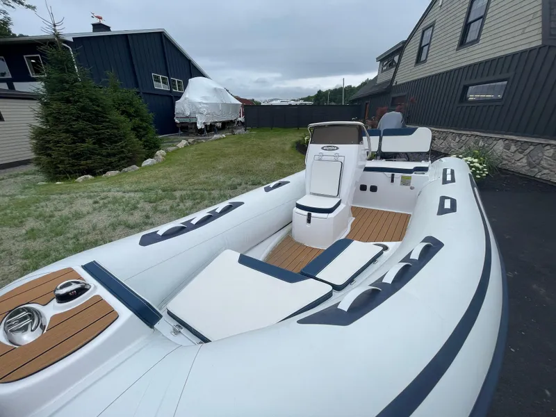 Slide: The Image of 2025 AB Inflatables Alumina 13 ALX boat displayed outdoors, showcasing sleek design and seating. - 13