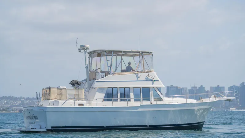 Slide: The Image of 2005 Mainship 43 Trawler Aft Cabin cruising on calm waters. - 11