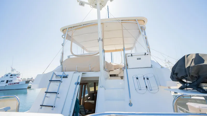 Slide: The Image of 2005 Mainship 43 Trawler Aft Cabin, rear view, docked under clear sky. - 14