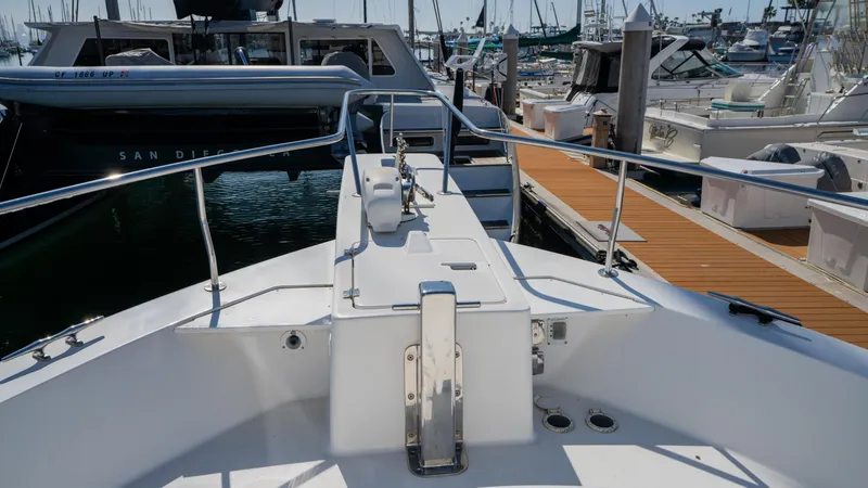 Slide: The Image of 2005 Mainship 43 Trawler Aft Cabin docked at marina, showcasing bow and deck features. - 18