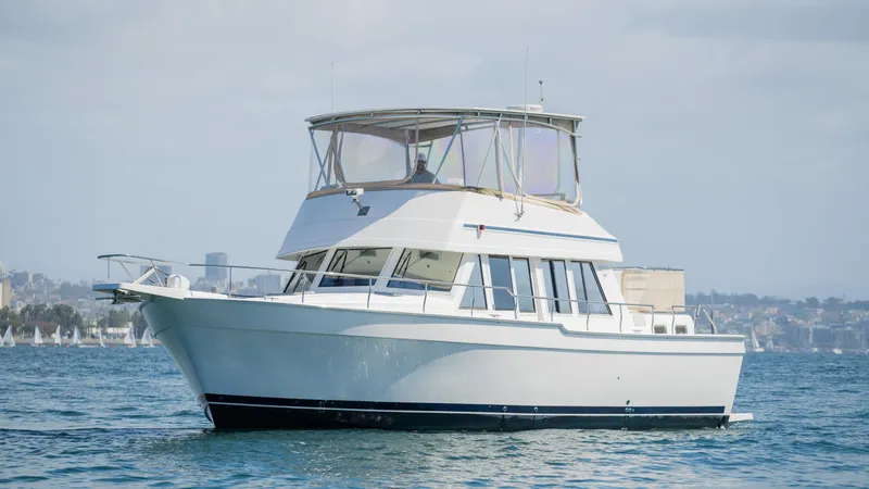 Slide: The Image of 2005 Mainship 43 Trawler Aft Cabin cruising on calm waters. - 2