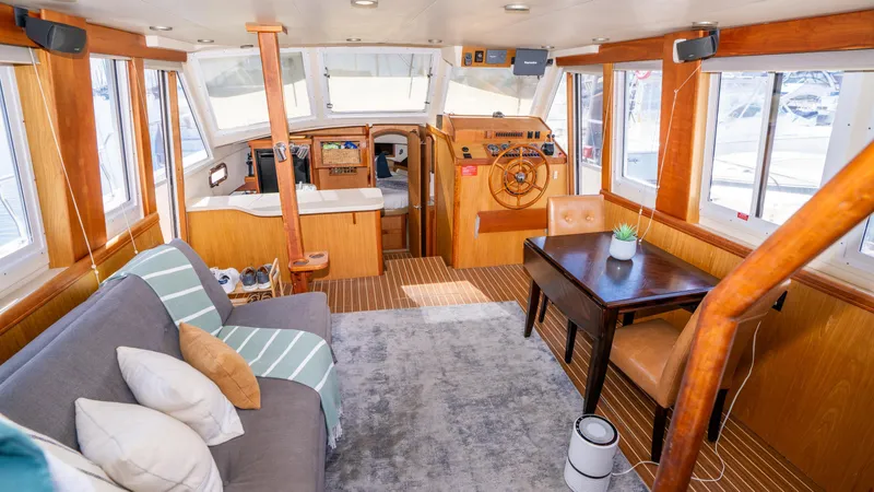 Slide: The Image of 2005 Mainship 43 Trawler Aft Cabin interior with cozy seating and dining area. - 20