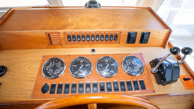 Slide: The Image of Control panel of 2005 Mainship 43 Trawler Aft Cabin with gauges and switches. - 32