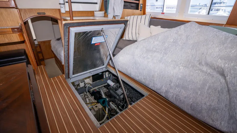 Slide: The Image of 2005 Mainship 43 Trawler Aft Cabin interior with open engine access panel. - 44