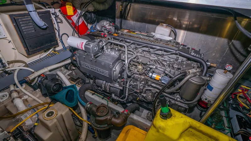 Slide: The Image of Engine room of 2005 Mainship 43 Trawler Aft Cabin, showcasing detailed machinery and components. - 45