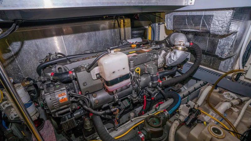Slide: The Image of Engine room of 2005 Mainship 43 Trawler Aft Cabin, showcasing detailed mechanical components. - 46