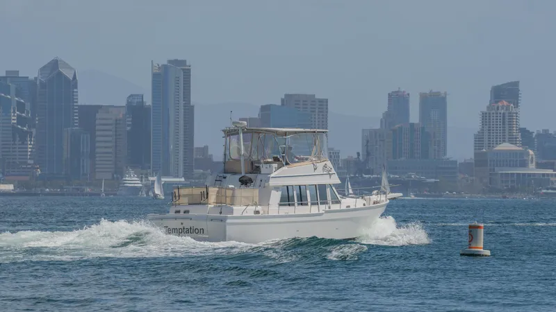 Slide: The Image of 2005 Mainship 43 Trawler Aft Cabin cruising near city skyline. - 6