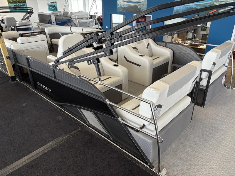Slide: The Image of 2025 Crest 220SLRC pontoon boat with spacious seating in showroom. - 5
