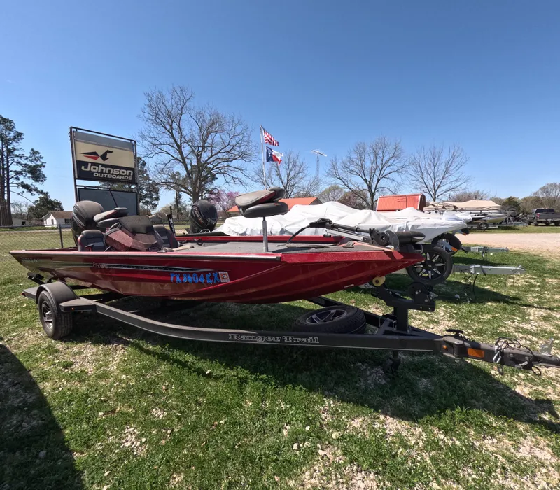 Slide: The Image of 2023 Ranger RT188 boat on trailer, displayed outdoors under clear sky. - 0