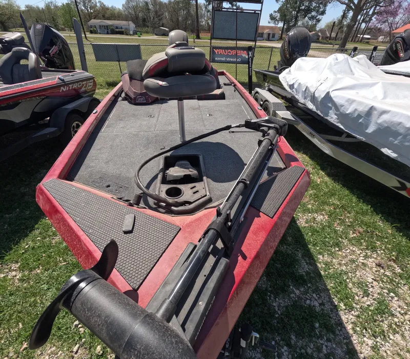 Slide: The Image of 2023 Ranger RT188 fishing boat with trolling motor, parked on grass. - 2