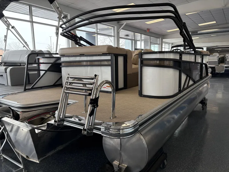 Slide: The Image of 2025 Crest 20L pontoon boat in showroom, featuring sleek design and comfortable seating. - 3