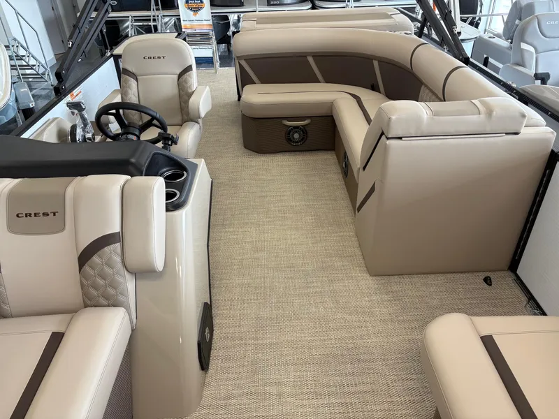 Slide: The Image of 2025 Crest 20L boat interior with beige seating and steering console. - 7