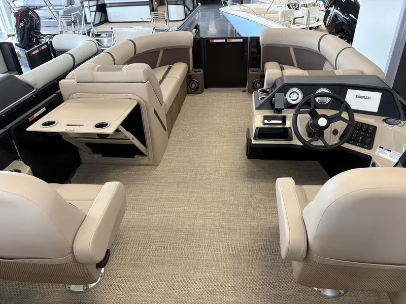 Slide: The Image of 2025 Crest 220 SLSC boat interior with beige seating and modern dashboard. - 7