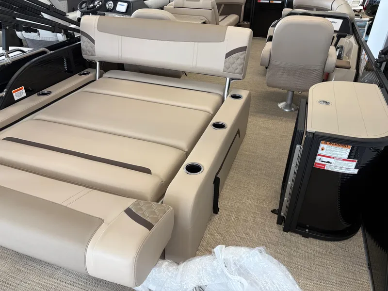 Slide: The Image of 2025 Crest 220 SLSC boat interior with beige seating and cup holders. - 9