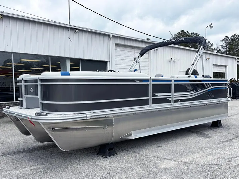 The Image of 2025 SunCatcher Select 322RF pontoon boat parked outside a building. - 1