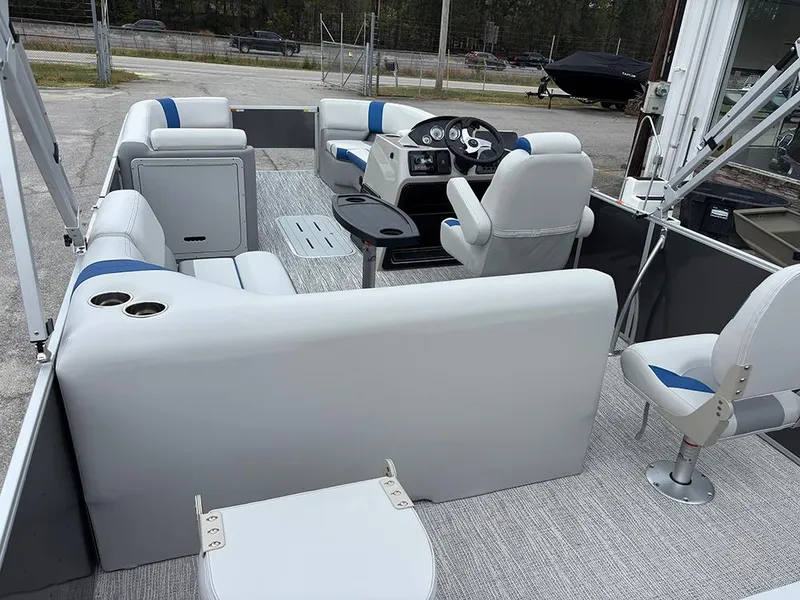Slide: The Image of 2025 SunCatcher Select 322RF pontoon boat interior with plush seating and modern dashboard. - 11