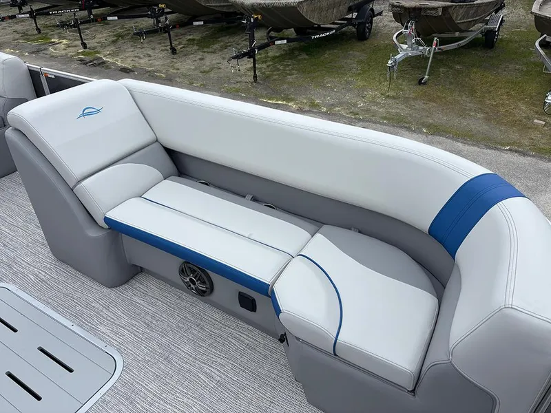 Slide: The Image of 2025 SunCatcher Select 322RF boat interior with white and blue cushioned seating. - 12