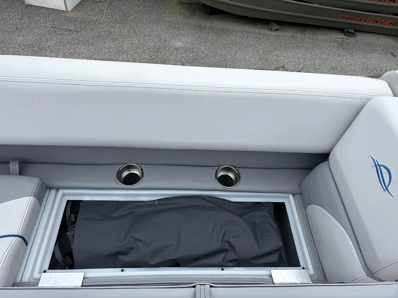 Slide: The Image of 2025 SunCatcher Select 322RF boat seating with storage compartment and cup holders. - 17