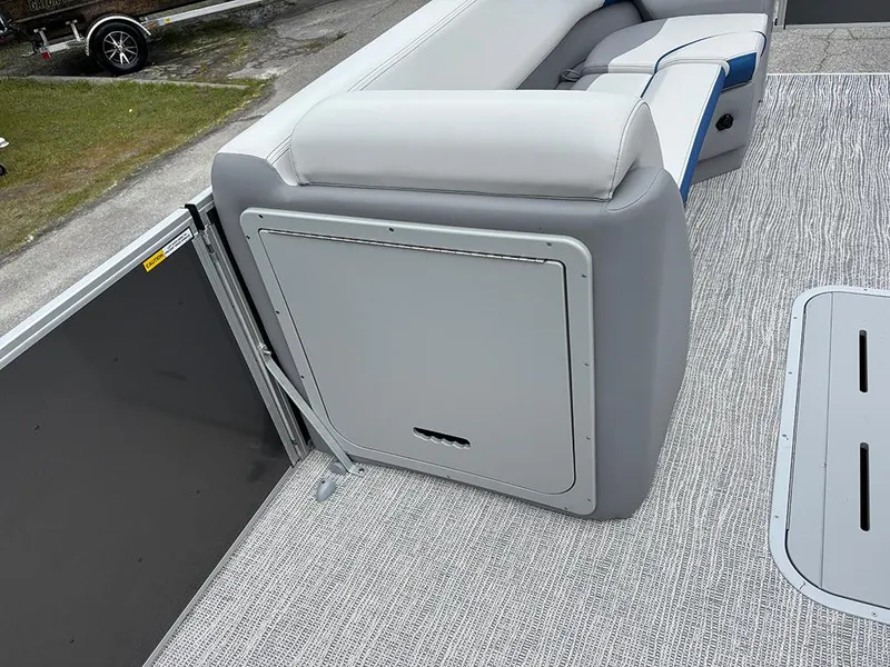 Slide: The Image of 2025 SunCatcher Select 322RF boat interior with gray seating and storage compartment. - 22