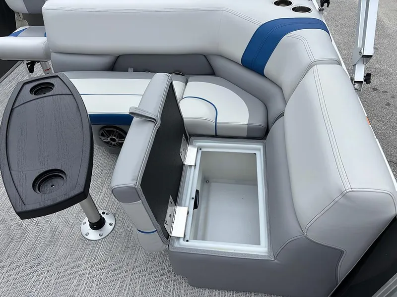 Slide: The Image of 2025 SunCatcher Select 322RF boat interior with open storage compartment and table. - 26