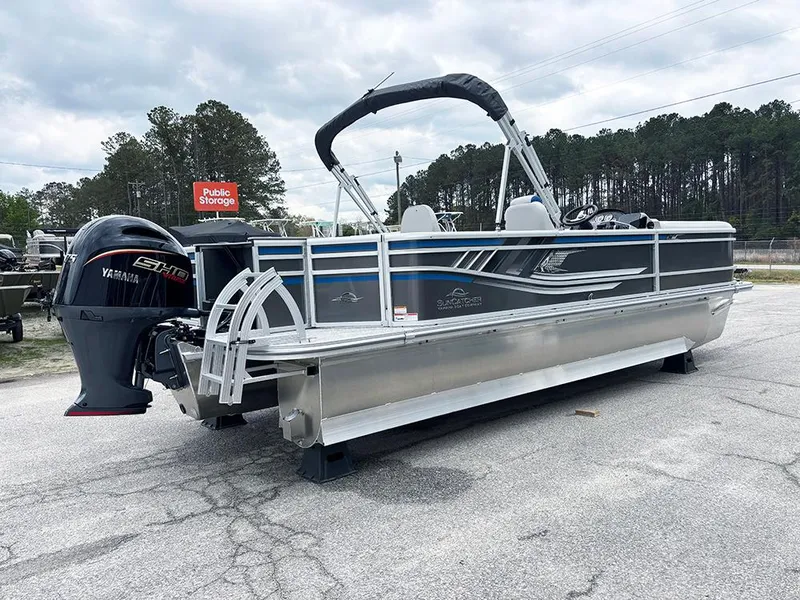 Slide: The Image of 2025 SunCatcher Select 322RF pontoon boat with Yamaha engine, parked outdoors. - 7