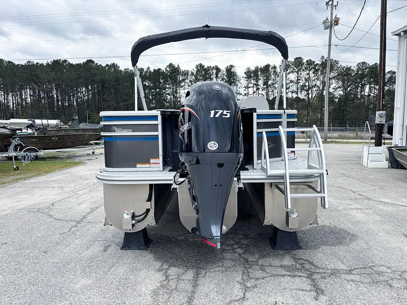 Slide: The Image of 2025 SunCatcher Select 322RF pontoon boat with 175 HP engine, parked outdoors. - 8