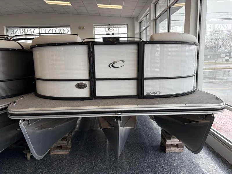 The Image of 2025 Crest 240SLC pontoon boat displayed indoors, front view. - 0