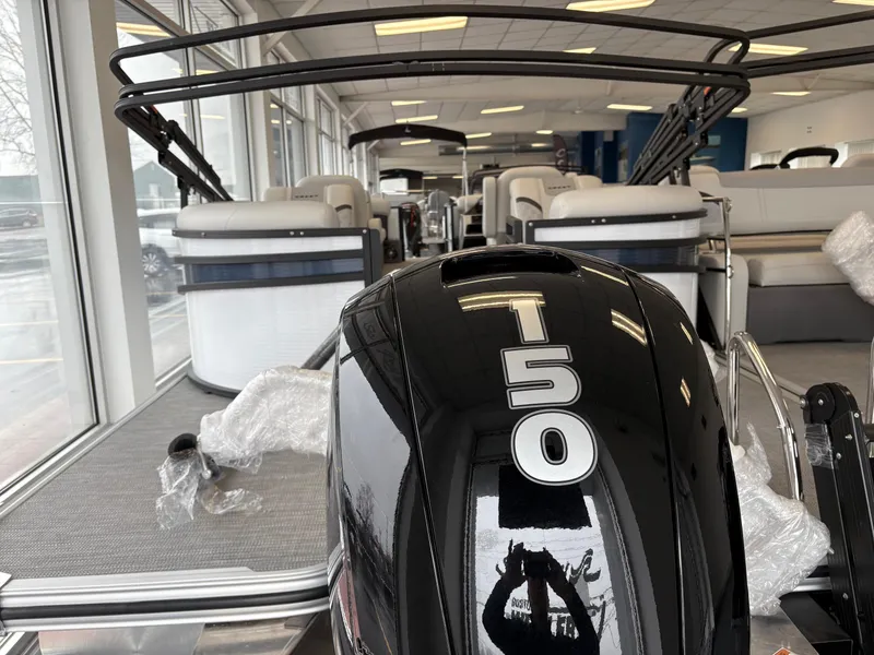 Slide: The Image of 2025 Crest 240SLC pontoon boat with T50 engine in showroom. - 2