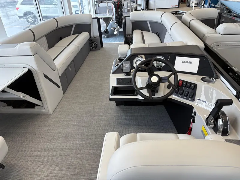Slide: The Image of Interior of a 2025 Crest 240SLC boat with modern seating and steering console. - 4
