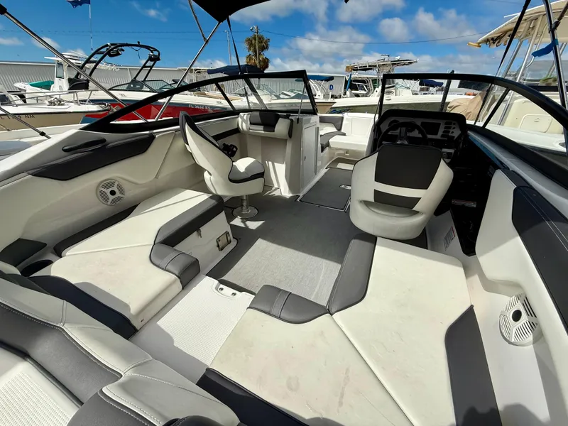 Slide: The Image of 2022 Yamaha Boats SX210 interior with modern seating and sleek design under a clear blue sky. - 6