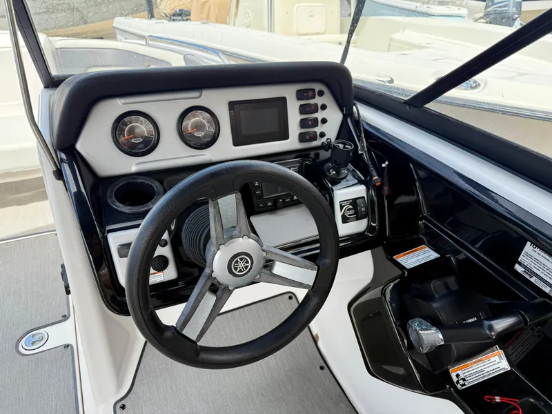 Slide: The Image of 2022 Yamaha Boats SX210 dashboard with steering wheel and control panel. - 8