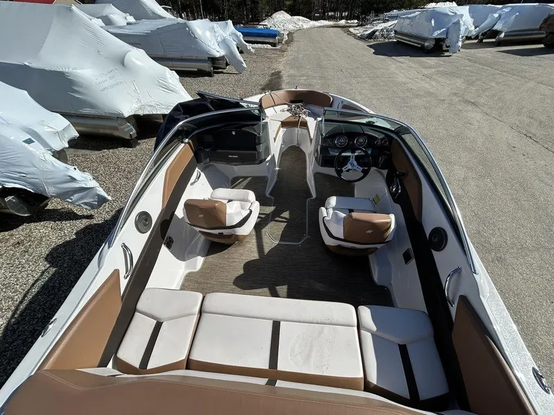 Slide: The Image of 2017 Four Winns Horizon 190 boat interior with tan and white seating, parked outdoors. - 7