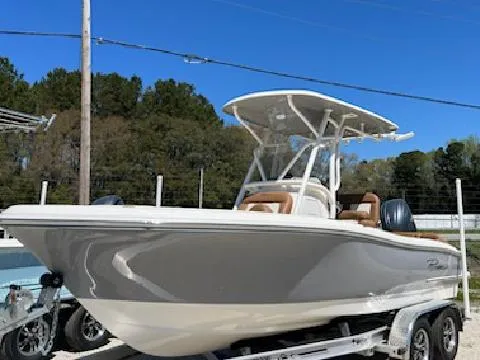 The Image of 2025 Pioneer 202 Islander boat on trailer, parked outdoors under clear blue sky. - 0