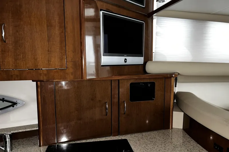 Slide: The Image of 2008 Carver 36 Mariner interior with wood cabinetry and mounted TV. - 10