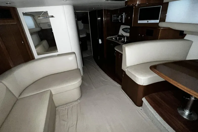 Slide: The Image of Interior of 2008 Carver 36 Mariner yacht with seating, kitchenette, and dining area. - 18