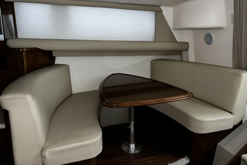 Slide: The Image of 2008 Carver 36 Mariner interior with beige seating and wooden table. - 19