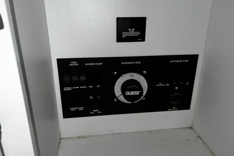 Slide: The Image of Control panel of a 2008 Carver 36 Mariner boat, featuring various switches and dials. - 26