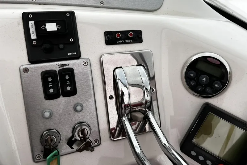 Slide: The Image of Control panel of a 2008 Carver 36 Mariner boat with throttle and gauges. - 33