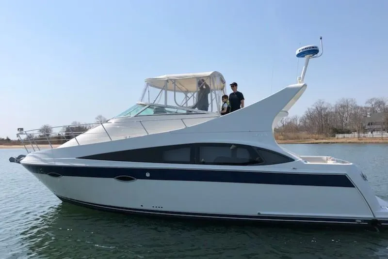 Slide: The Image of 2008 Carver 36 Mariner yacht on calm water with people on deck. - 5