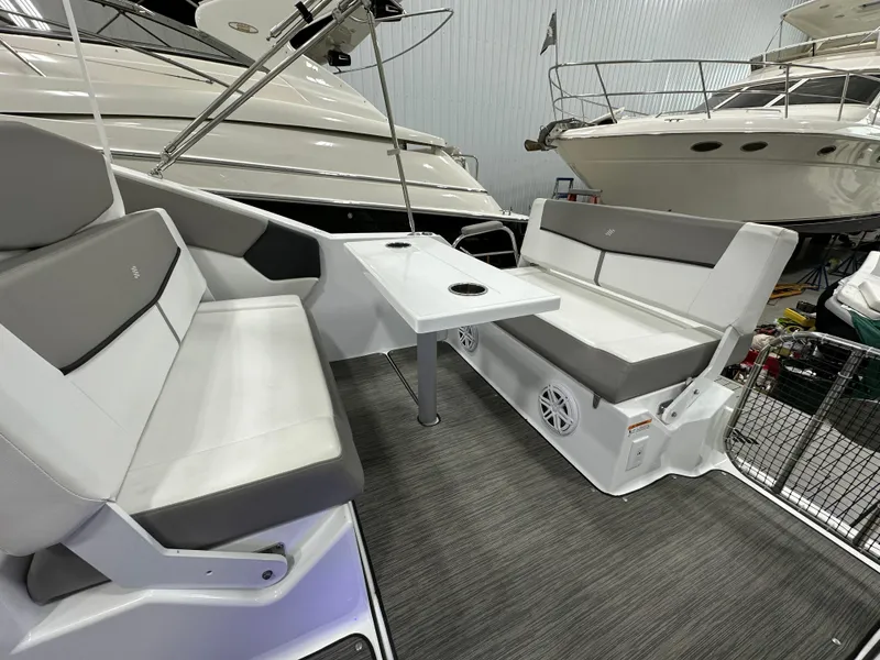 Slide: The Image of 2021 Four Winns Vista 275 boat interior with gray seating and a central table. - 10