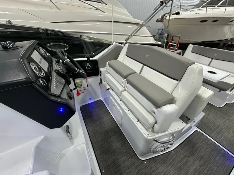 Slide: The Image of 2021 Four Winns Vista 275 boat interior with modern seating and control panel. - 11