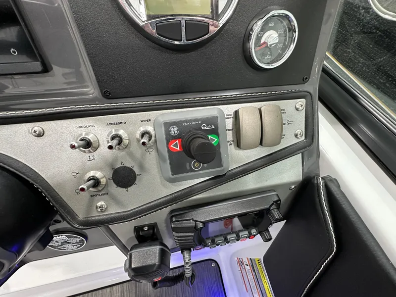 Slide: The Image of Control panel of 2021 Four Winns Vista 275 boat, featuring switches and gauges. - 13