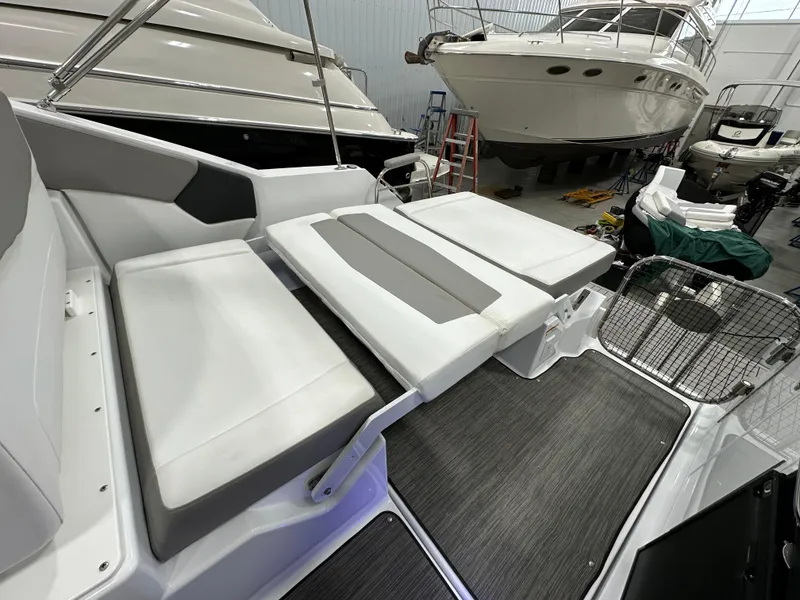 Slide: The Image of 2021 Four Winns Vista 275 boat interior with adjustable seating in a showroom. - 14