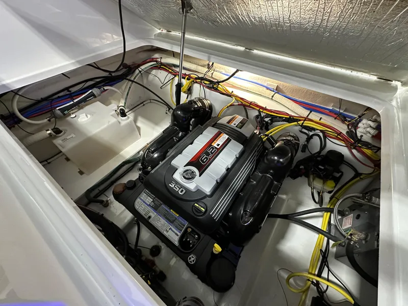 Slide: The Image of Engine compartment of 2021 Four Winns Vista 275 boat, showcasing a powerful engine setup. - 23
