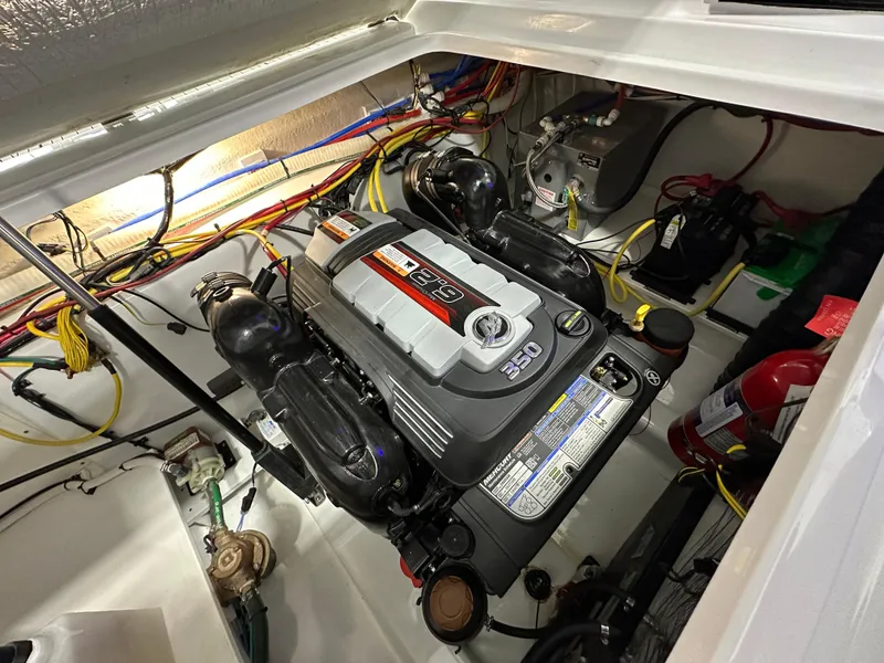 Slide: The Image of Engine compartment of 2021 Four Winns Vista 275 boat, showcasing detailed wiring and components. - 24
