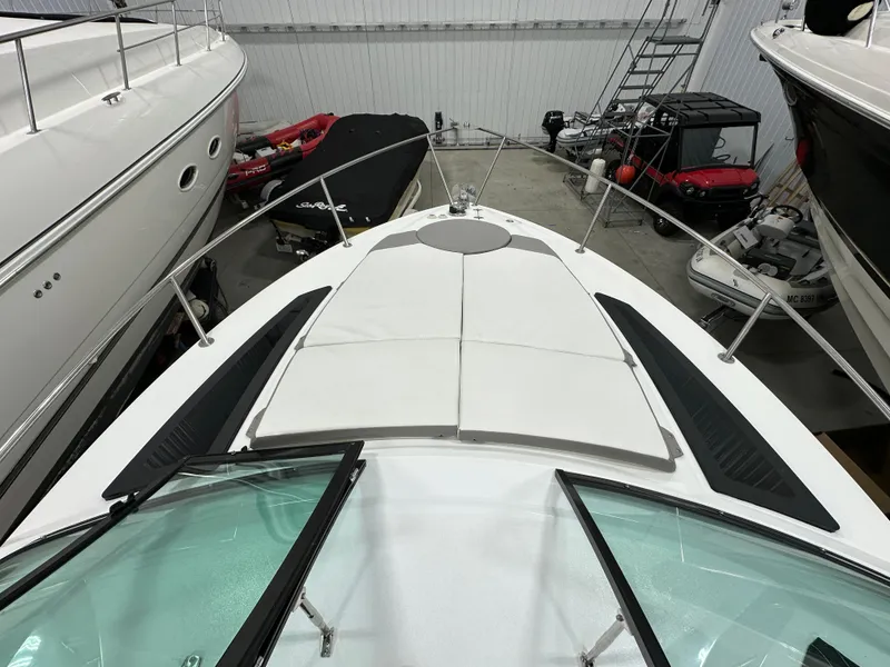 Slide: The Image of 2021 Four Winns Vista 275 boat in storage, featuring a spacious deck and sleek design. - 26